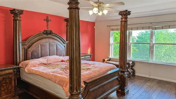 a bedroom with a bed window and lamp