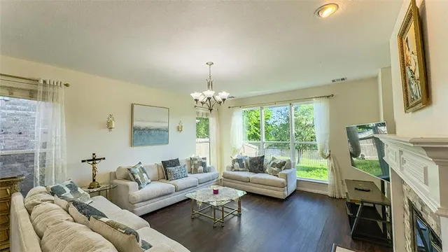 a living room with furniture and a chandelier
