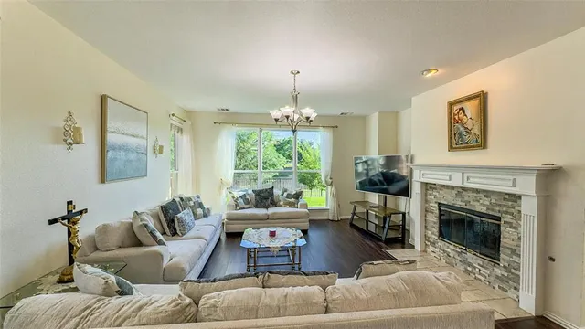 a living room with furniture a window and a fireplace
