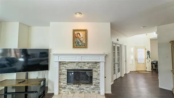 a living room with a fireplace and a flat screen tv