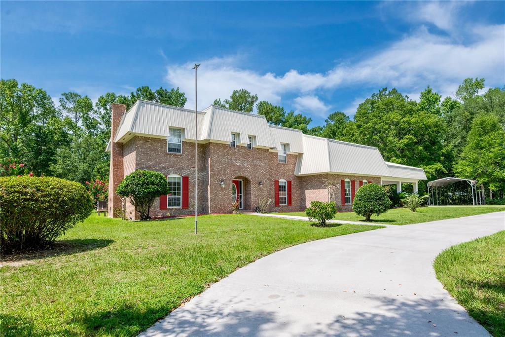 a front view of house with yard and green space
