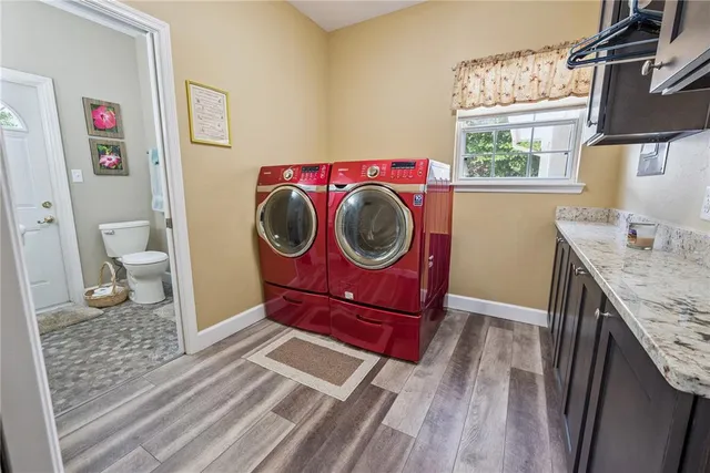 a view of a dining room with furniture a chandelier and wooden floor