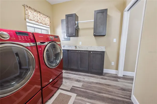 a dining room with furniture a chandelier and wooden floor