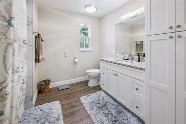 an aerial view of a house with a swimming pool and outdoor seating