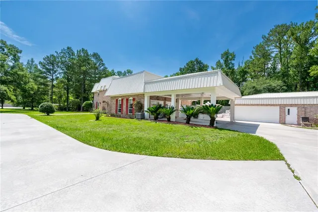 an aerial view of a house with swimming pool and garden