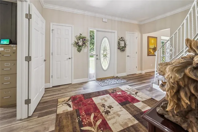 a living room with furniture a fireplace and a large window