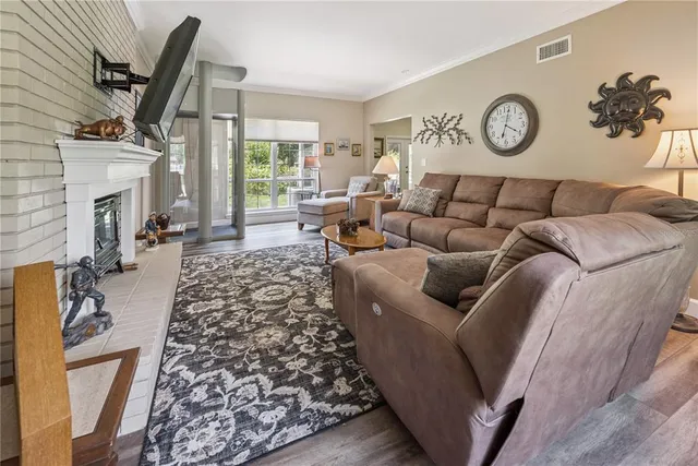 a living room with furniture a flat screen tv and a fireplace