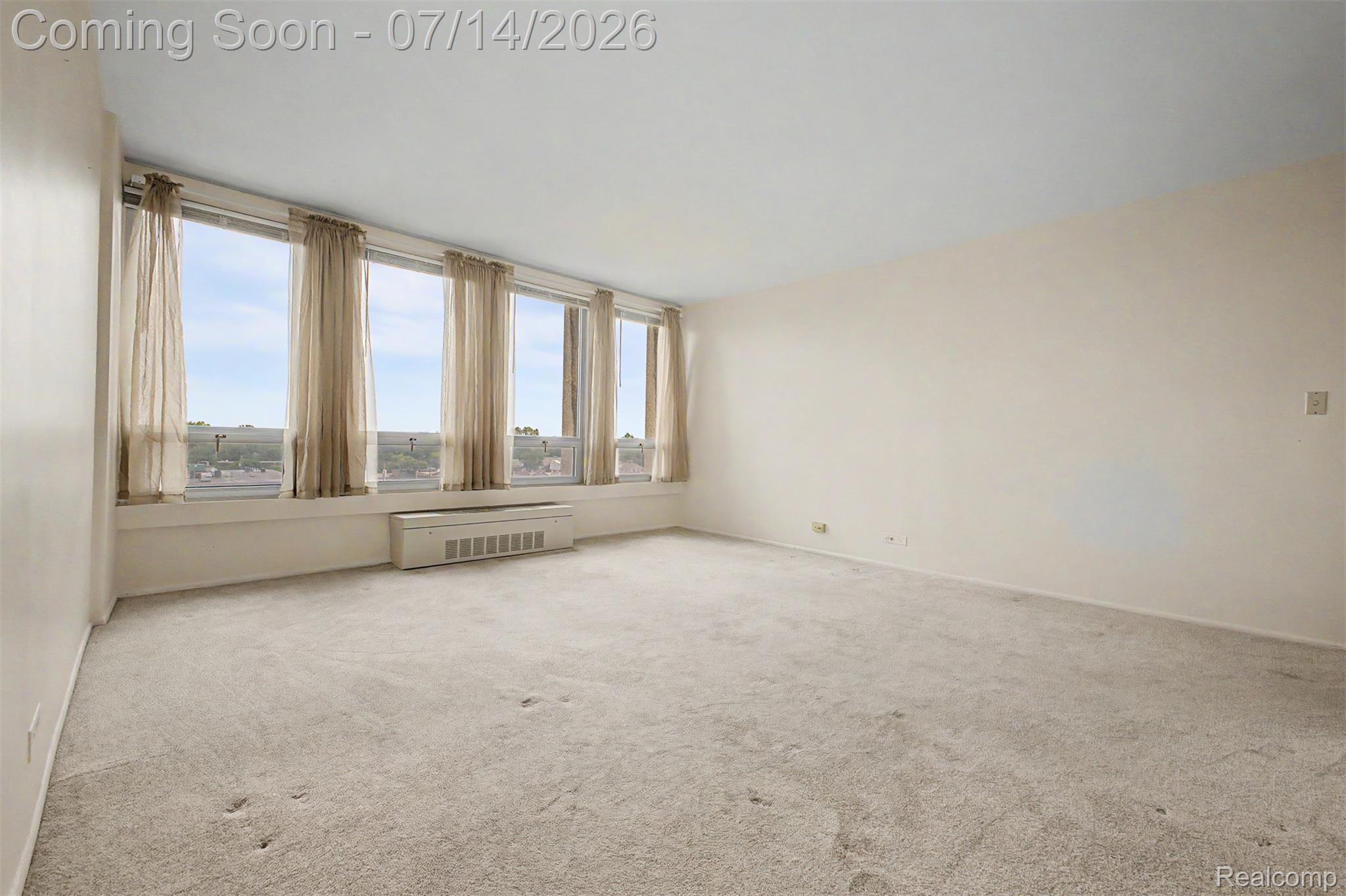 22700 Garrison Street, Unit 707 Dearborn, MI 48124 - Photo 4 of 22 Expansive room with wall-to-wall carpeting and neutral wall tones