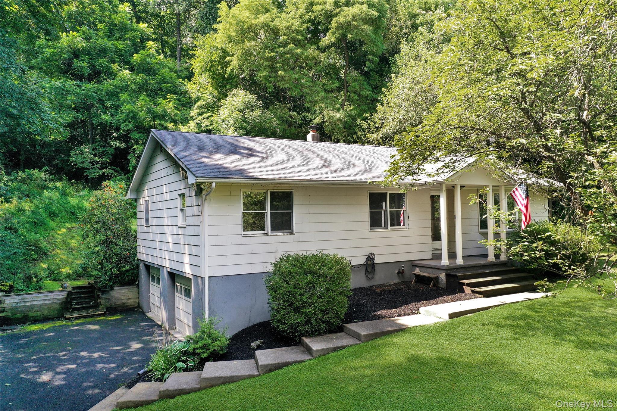 a front view of a house with a garden