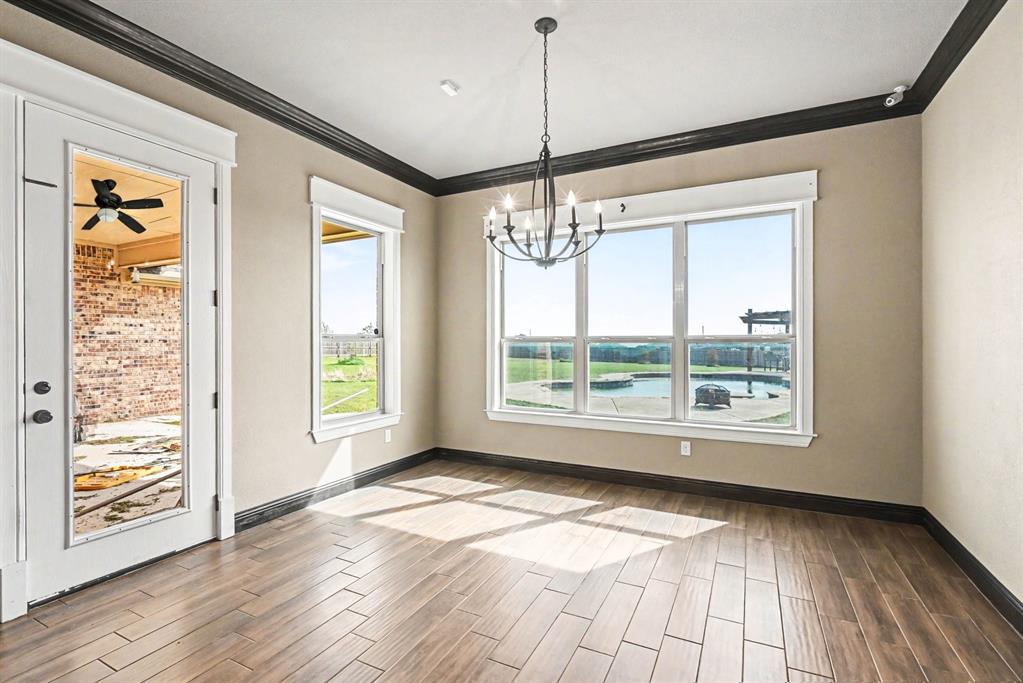 104 Stanford Lane Springtown, TX 76082 - Photo 4 of 28 a view of an empty room with wooden floor and a window