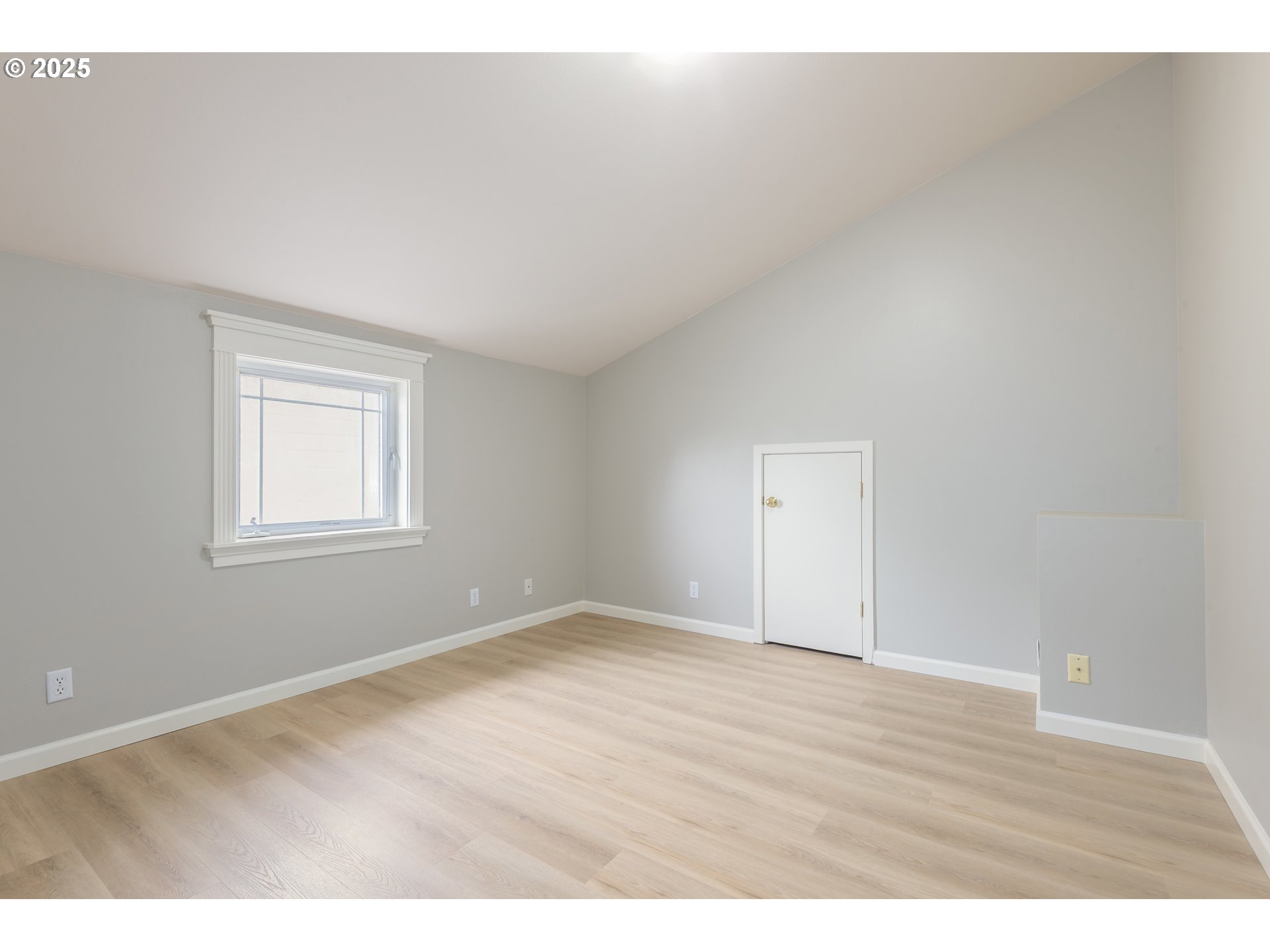 1507 Bogart Lane Eugene, OR 97401 - Photo 23 of 41 a view of an empty room with wooden floor and a window