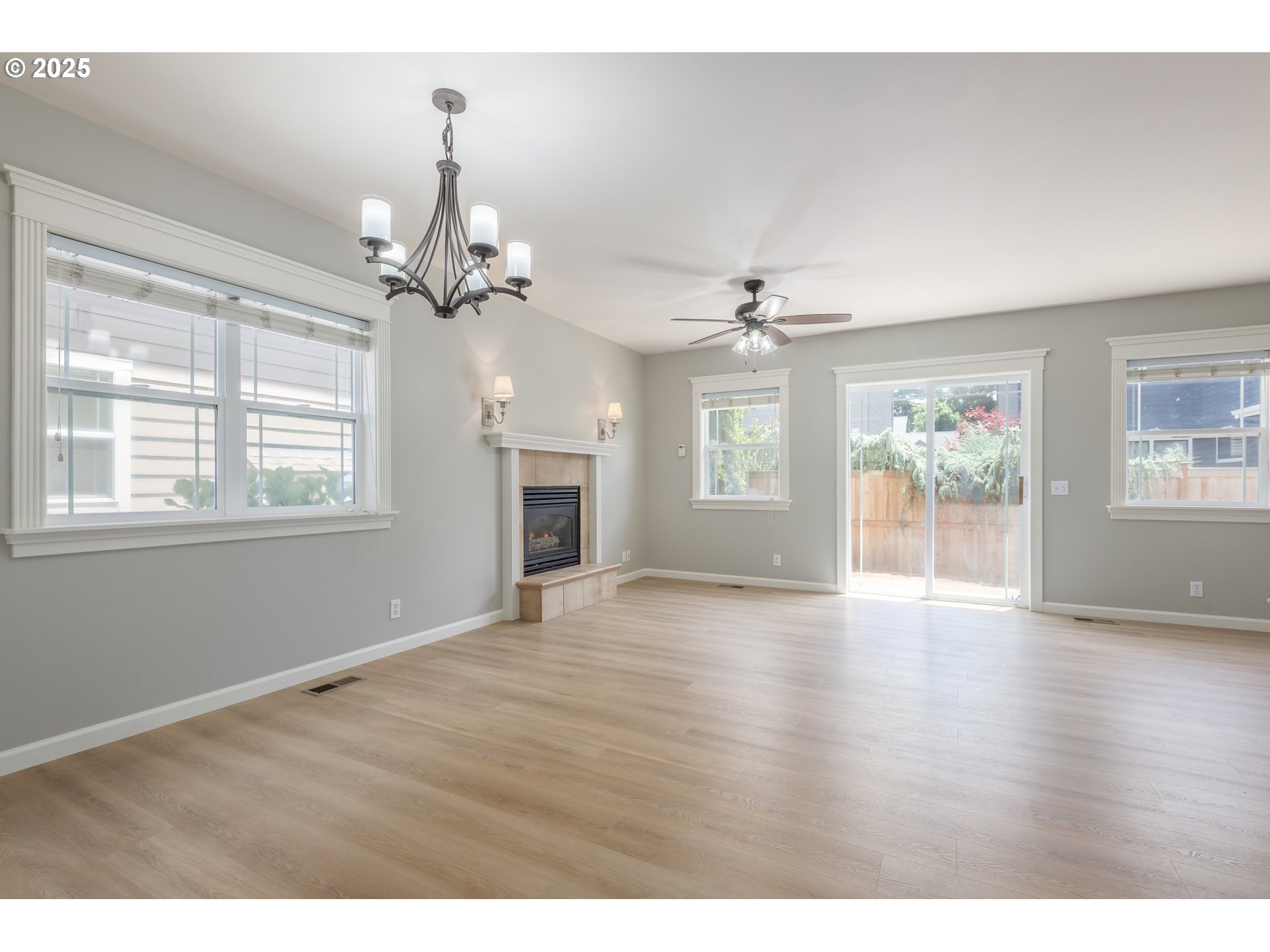 1507 Bogart Lane Eugene, OR 97401 - Photo 5 of 41 a view of an empty room with a window and wooden floor