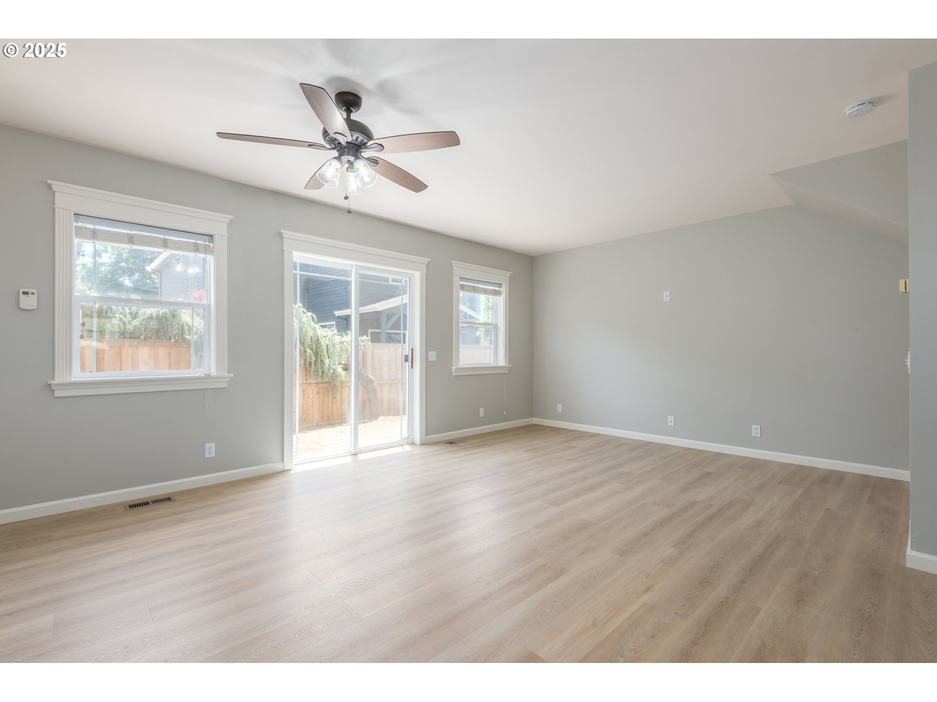 1507 Bogart Lane Eugene, OR 97401 - Photo 6 of 41 a view of an empty room with wooden floor and a window