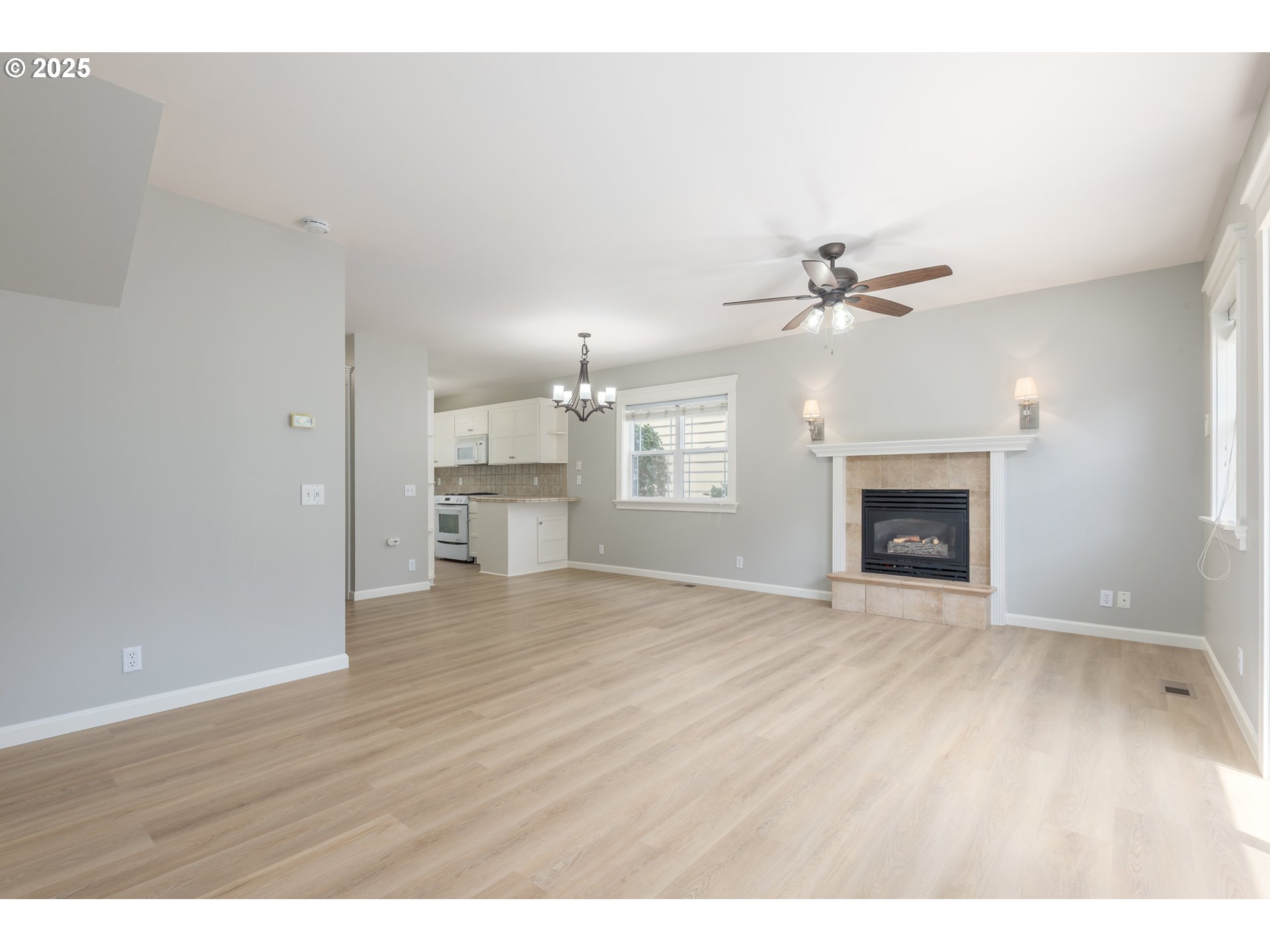 1507 Bogart Lane Eugene, OR 97401 - Photo 7 of 41 a view of an empty room with a fireplace and wooden floor