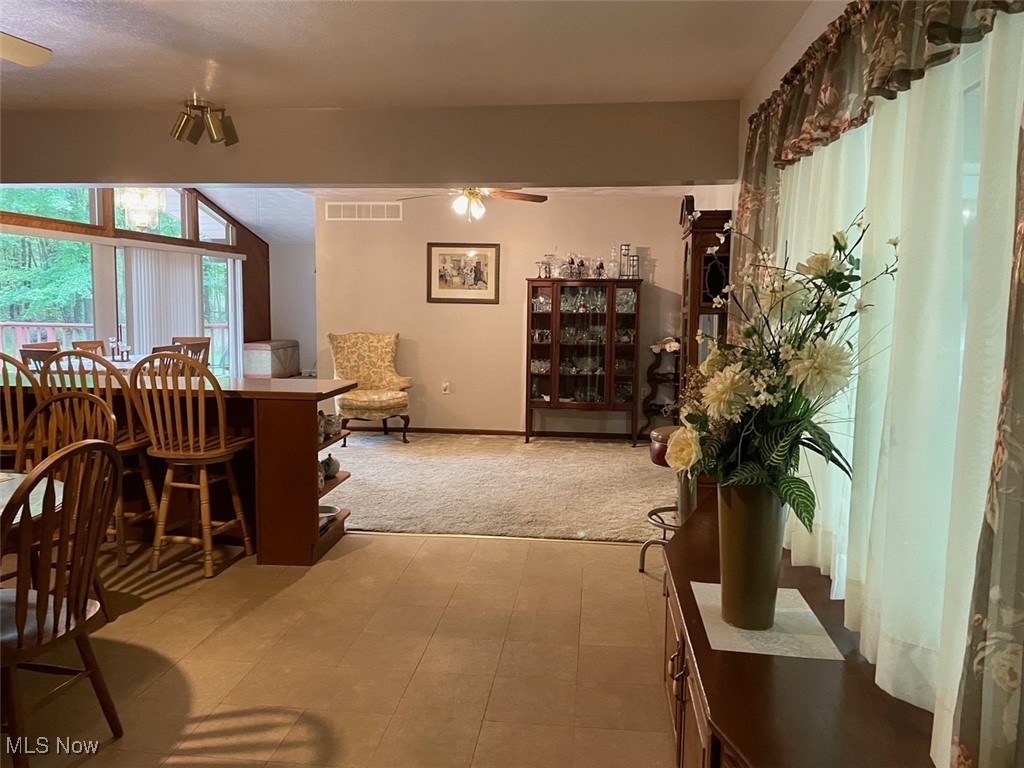 1503 South Leavitt Road Southwest Warren, OH 44481 - Photo 10 of 32 Carpeted dining room featuring ceiling fan and vaulted ceiling