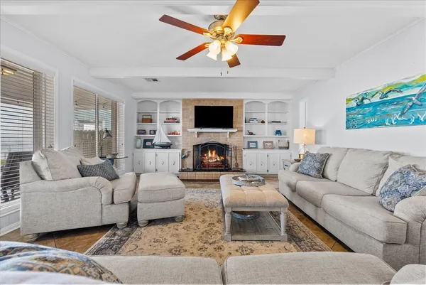 a view of a dining room with furniture and a chandelier