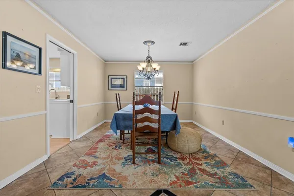a spacious bedroom with a bed and glass table