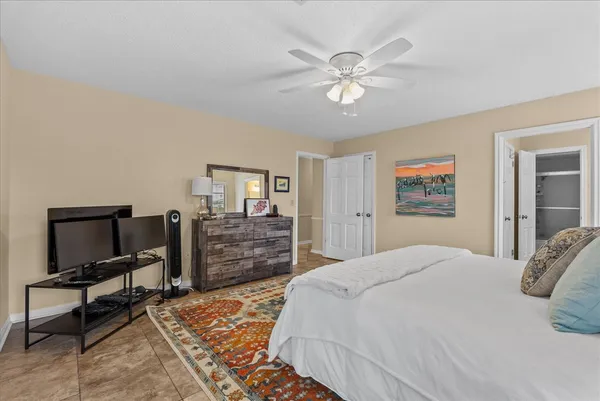a bedroom with a large bed and a chandelier