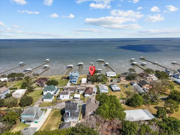 a view of a patio with a table chairs and a backyard