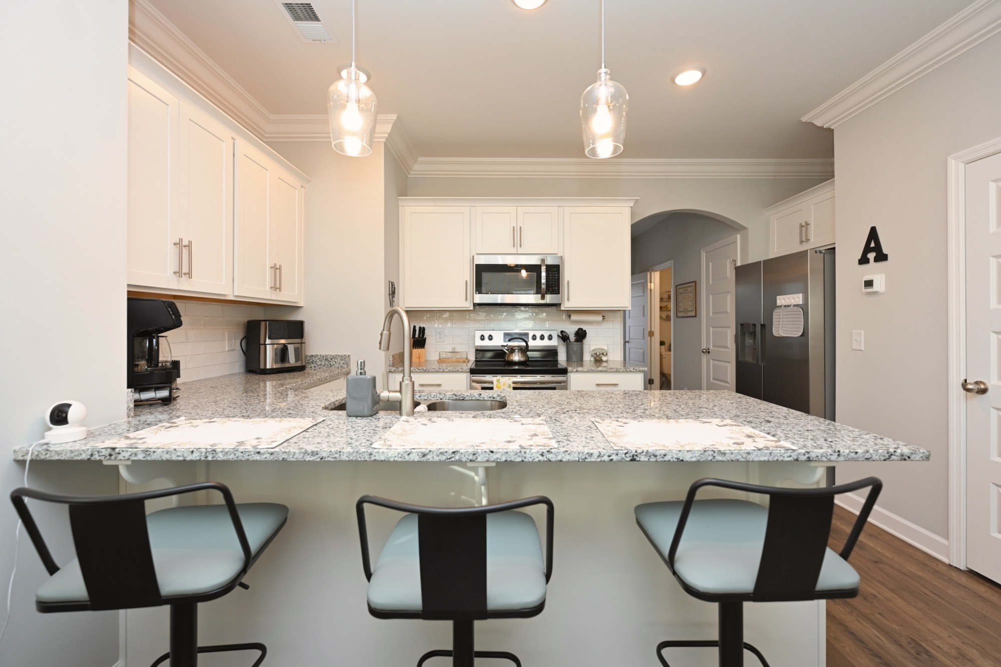 436 Withrow Way Gallatin, TN 37066 - Photo 13 of 41 a kitchen with granite countertop a counter space chairs cabinets and stainless steel appliances
