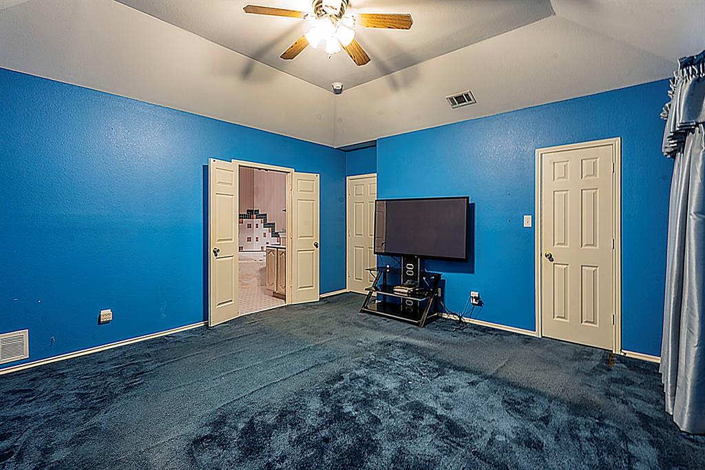 8317 Lake Bend Drive Rowlett, TX 75088 - Photo 16 of 35 2nd view of master bedroom with carpet floors, ceiling fan and a walk in closet.
