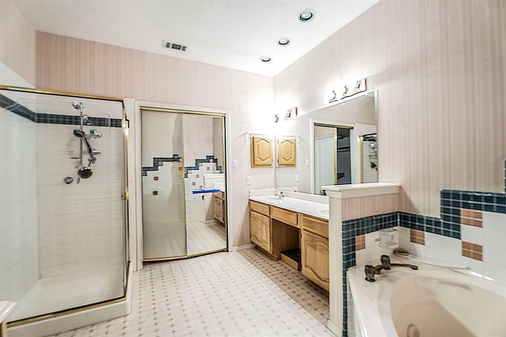8317 Lake Bend Drive Rowlett, TX 75088 - Photo 18 of 35 Master bathroom featuring a garden tub, double vanity, and a shower, medicine cabinet