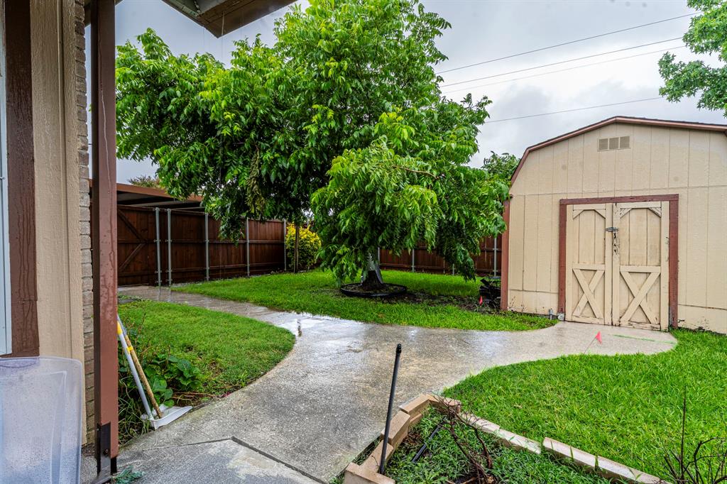 8317 Lake Bend Drive Rowlett, TX 75088 - Photo 30 of 35 View of yard featuring a storage shed