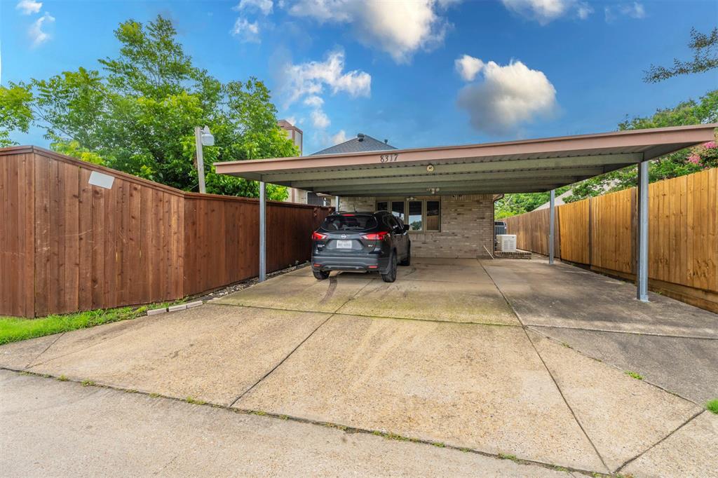 8317 Lake Bend Drive Rowlett, TX 75088 - Photo 34 of 35 View of parking / parking lot with driveway and a carport