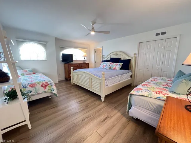 a bedroom with two beds and a window