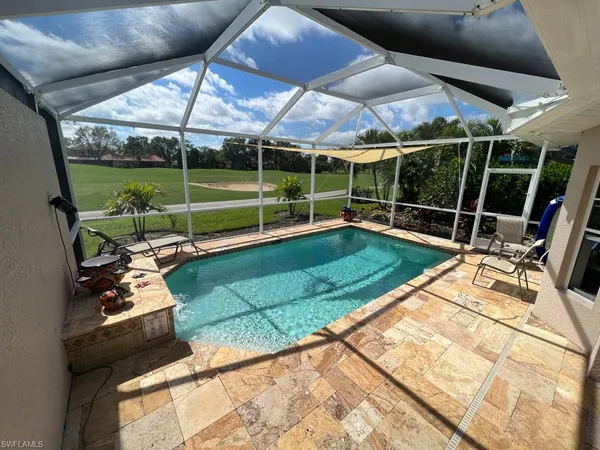 a view of a backyard with sitting area and furniture