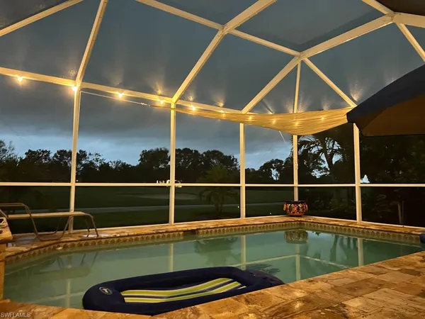 a view of a swimming pool with a window and wooden floor