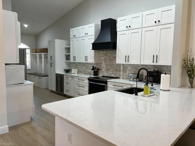 a kitchen with stainless steel appliances a stove sink and cabinets
