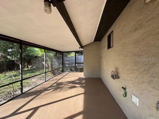 a spacious bedroom with a large window and a balcony