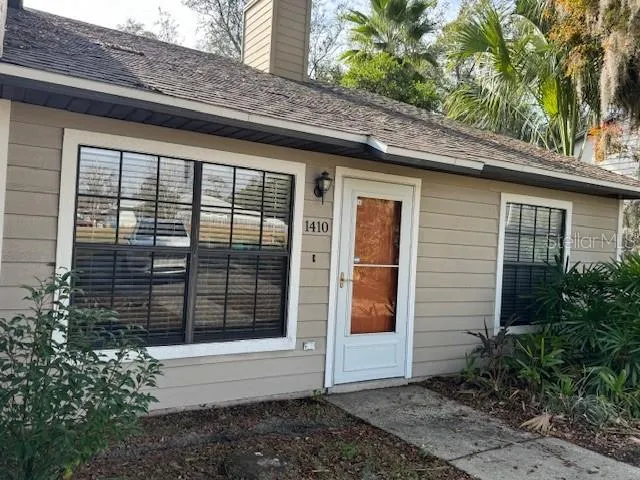 a front view of a house with plants