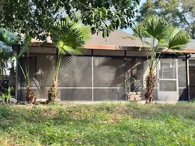 a white house with tree in the background