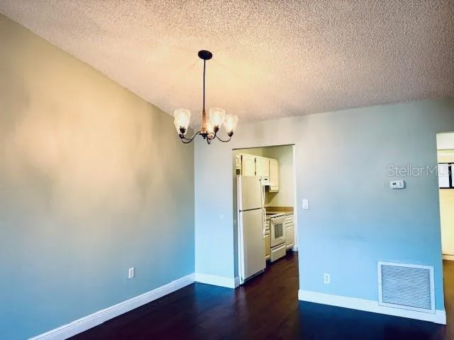 a view of a room with wooden floor closet and windows