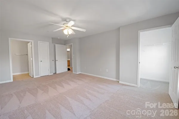 a view of a livingroom with a ceiling fan and window