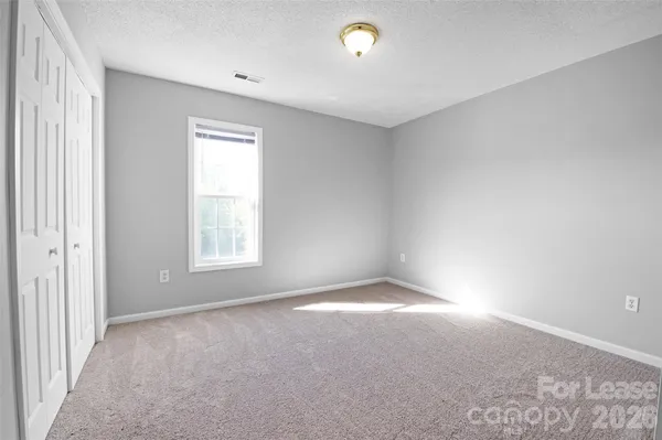 a view of an empty room and closet area