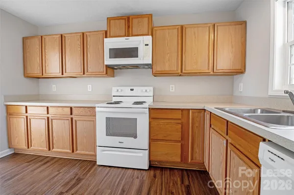 a kitchen with a stove and a white refrigerator