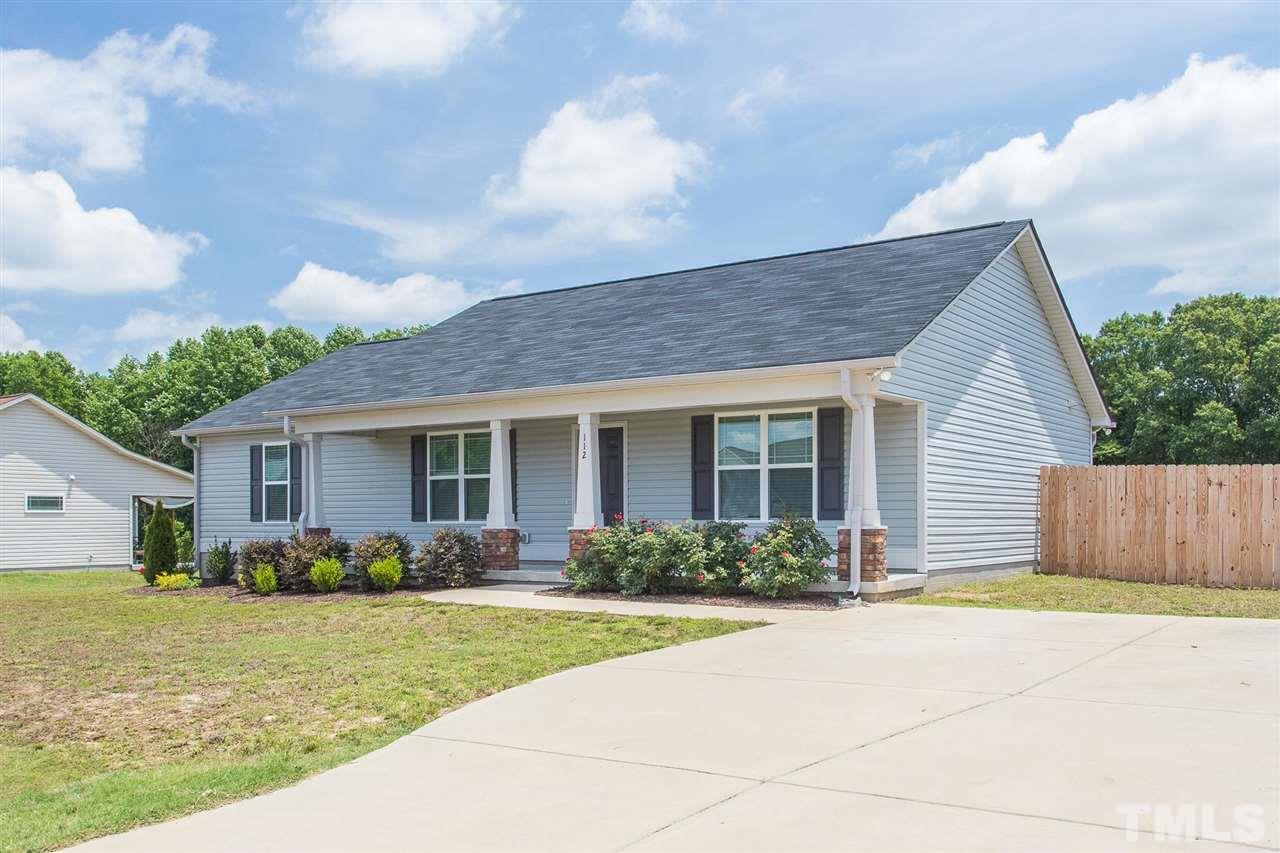 112 Willow Ridge Circle Willow Spring, NC 27592 - Photo 2 of 30 a front view of house with yard outdoor seating and barbeque oven