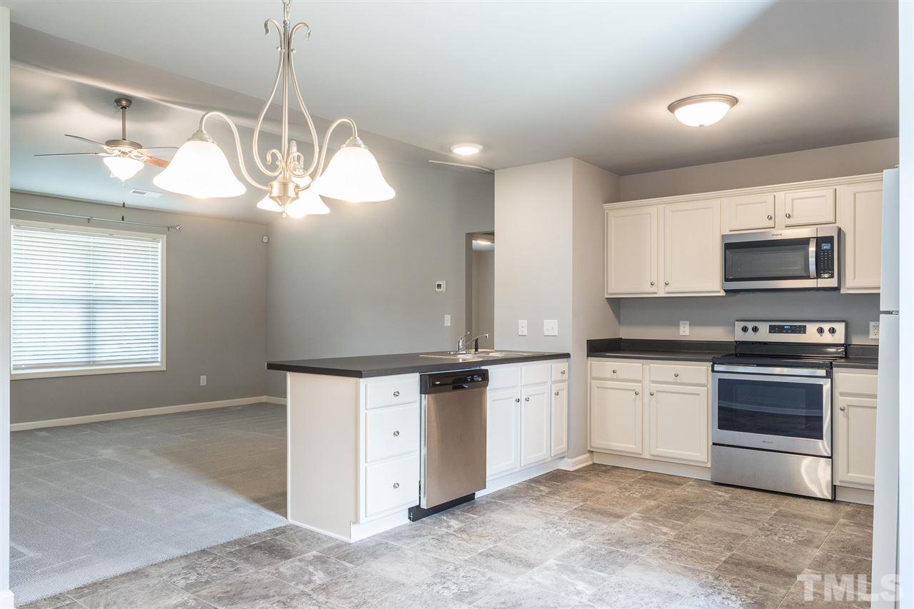 112 Willow Ridge Circle Willow Spring, NC 27592 - Photo 14 of 30 a kitchen with stainless steel appliances granite countertop a stove and a sink