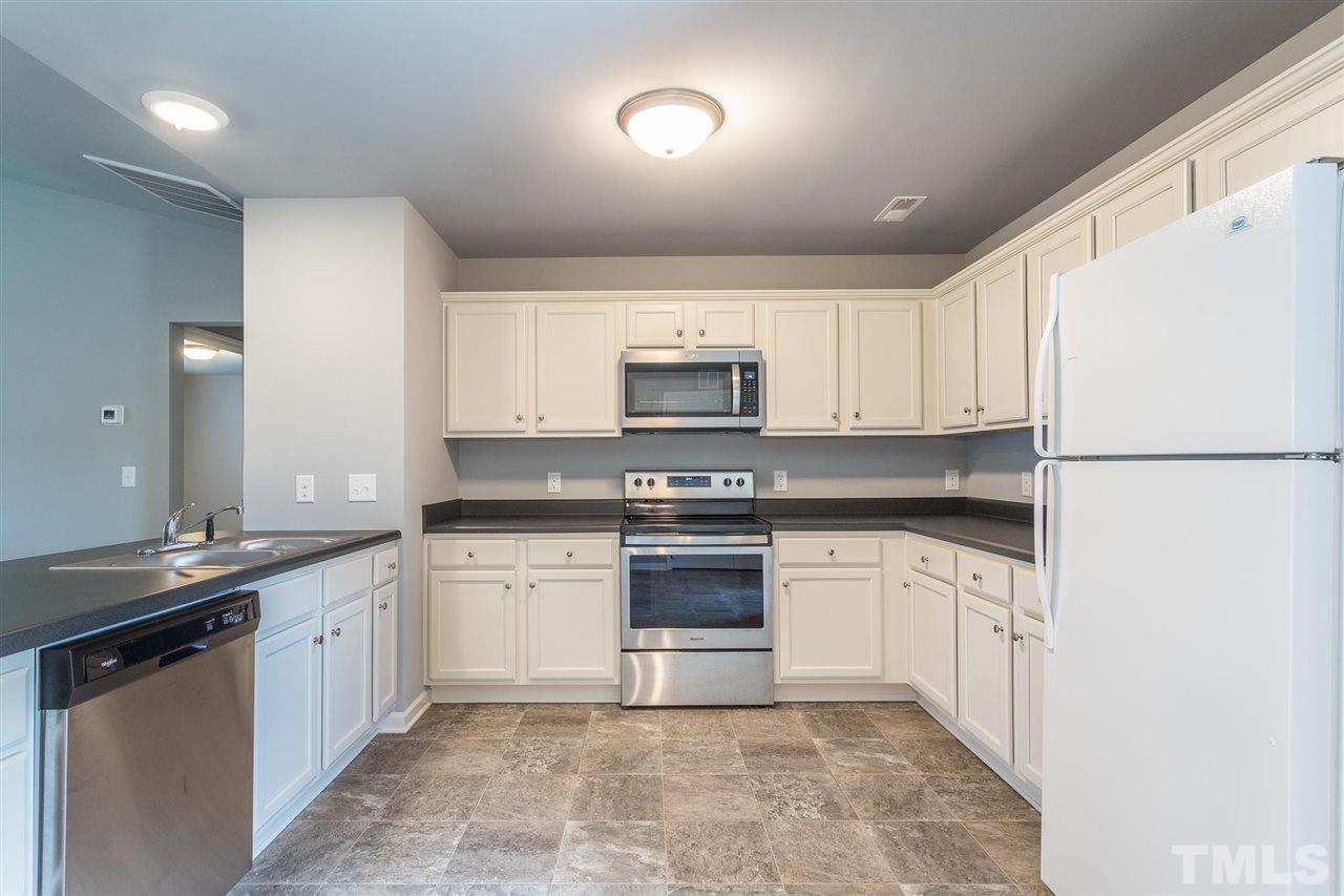 112 Willow Ridge Circle Willow Spring, NC 27592 - Photo 15 of 30 a kitchen with granite countertop white cabinets and white appliances