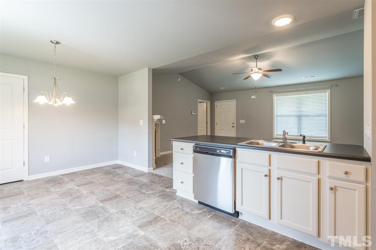 112 Willow Ridge Circle Willow Spring, NC 27592 - Photo 18 of 30 a large white kitchen with a sink and dishwasher
