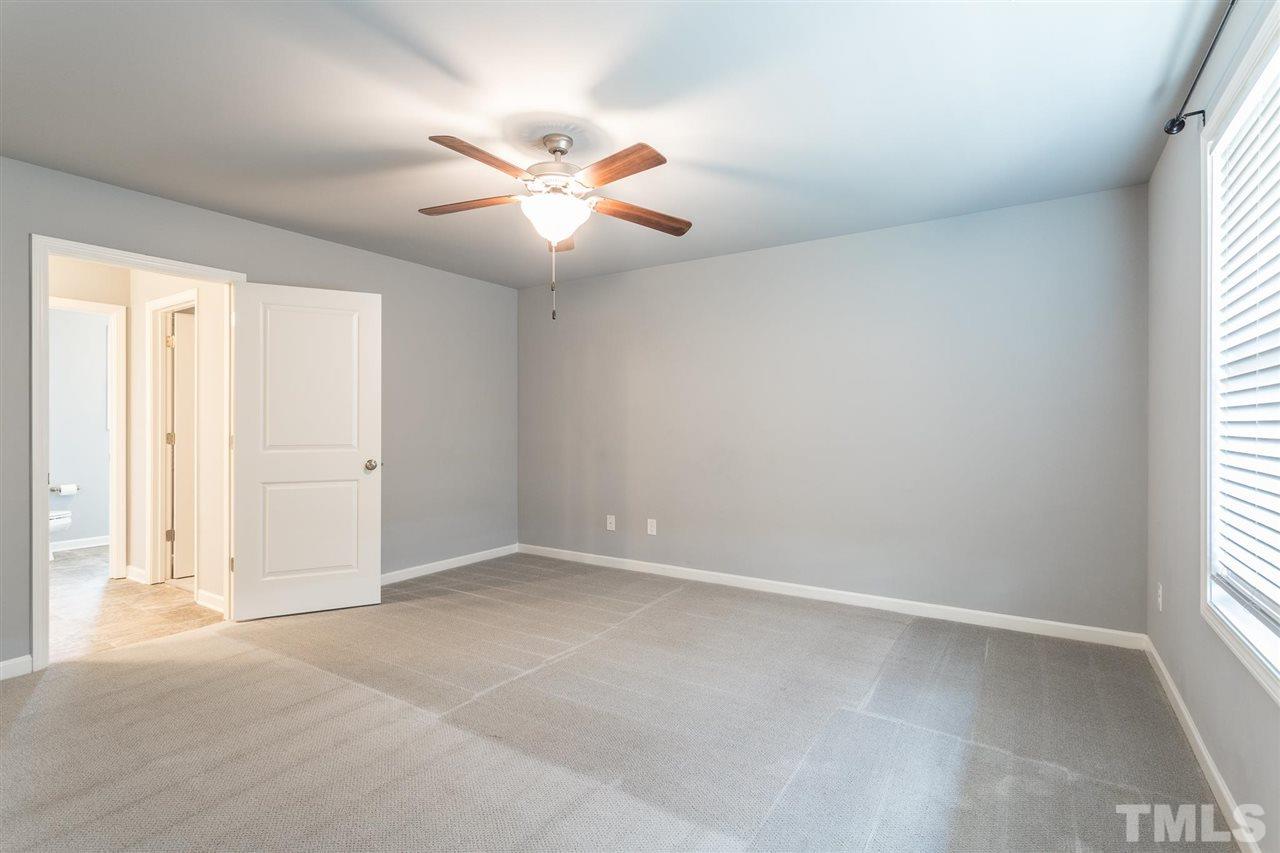 112 Willow Ridge Circle Willow Spring, NC 27592 - Photo 20 of 30 an empty room with windows and fan