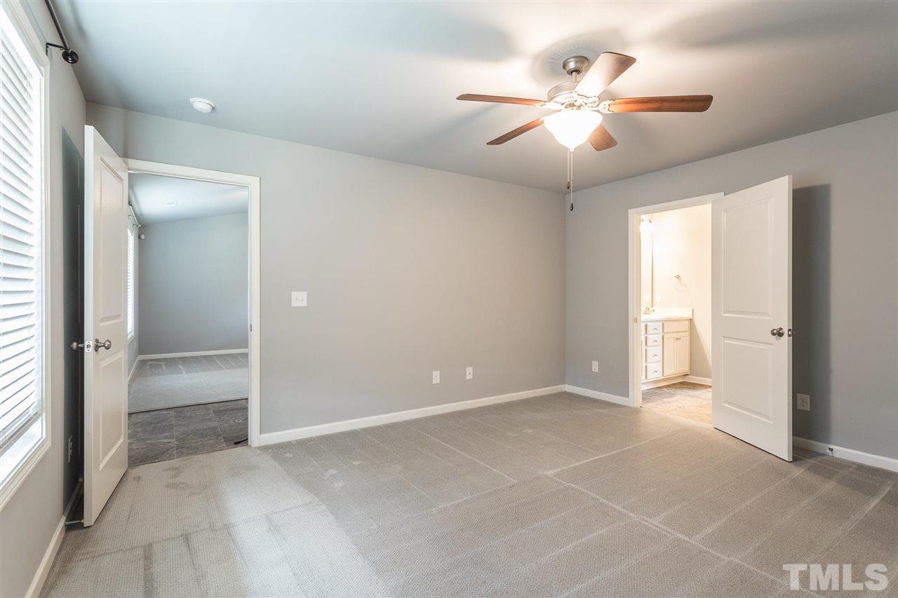 112 Willow Ridge Circle Willow Spring, NC 27592 - Photo 21 of 30 a view of an empty room with a ceiling fan and window