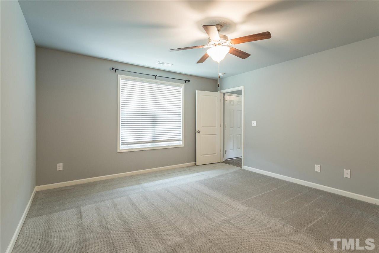 112 Willow Ridge Circle Willow Spring, NC 27592 - Photo 22 of 30 an empty room with fan and windows