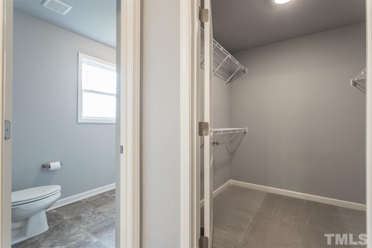 112 Willow Ridge Circle Willow Spring, NC 27592 - Photo 24 of 30 a bathroom with a granite countertop toilet and a window