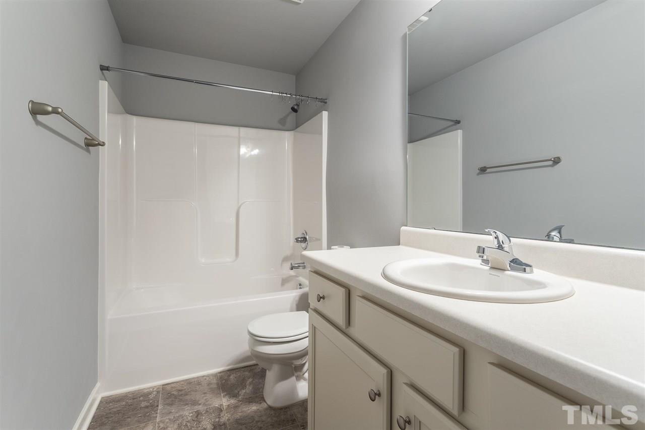 112 Willow Ridge Circle Willow Spring, NC 27592 - Photo 30 of 30 a bathroom with a sink toilet vanity and shower