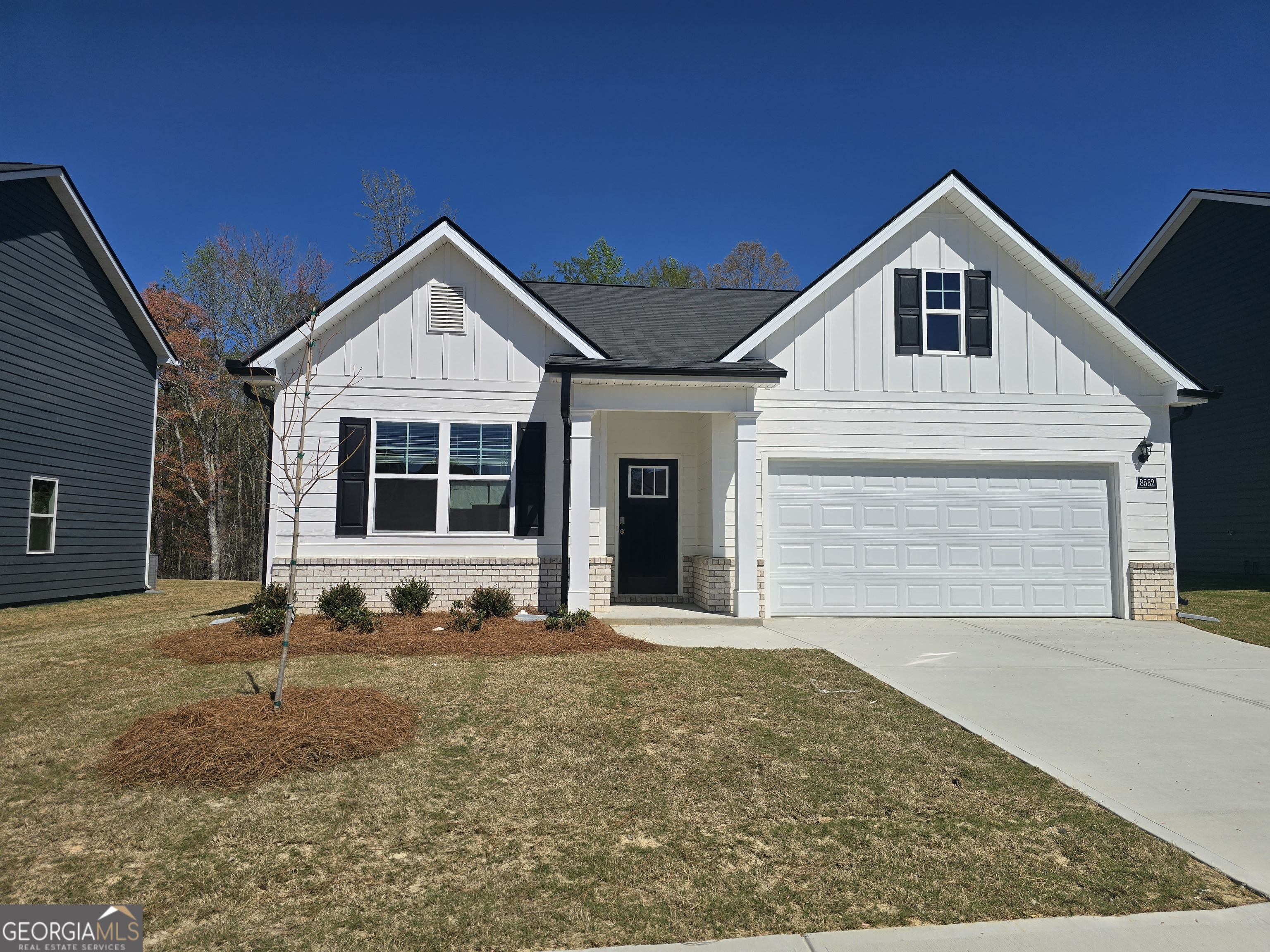 8582 Preakness Pass Snellville, GA 30039 - Photo 1 of 1 a front view of a house with a yard