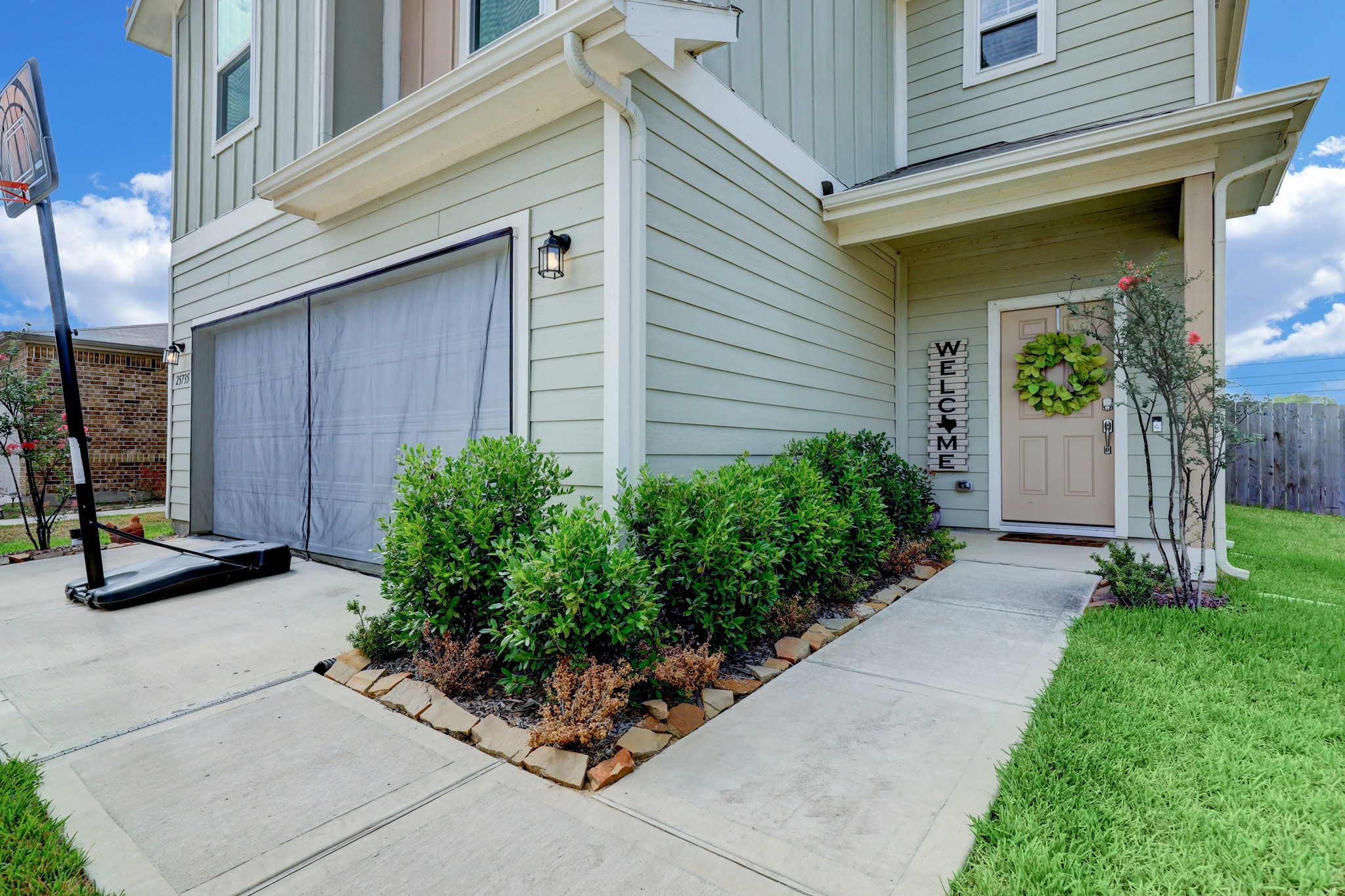 25735 Royal Catchfly Road Katy, TX 77493 - Photo 2 of 31 Inviting entry surrounded by expansive green lawn and lush landscaping.
